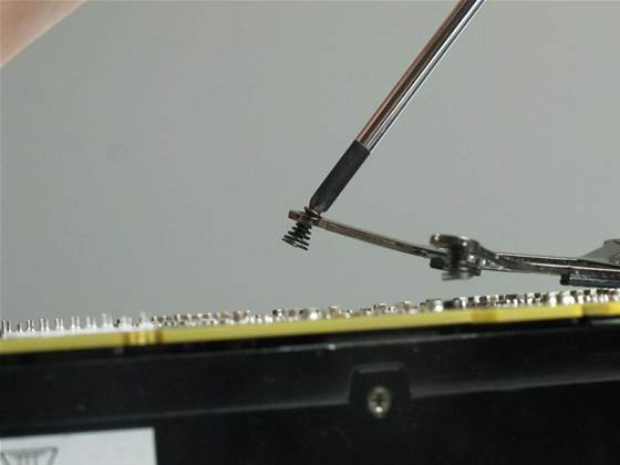 The order in which you undo these is not particularly important, however <b>take care not to lose the springs that are attached to the screws</b> as they are essential for creating an even pressure when re-mounting the heatsink. Move the X-bracket aside and keep it with the screws and springs; separate to the other two groups of screws.
