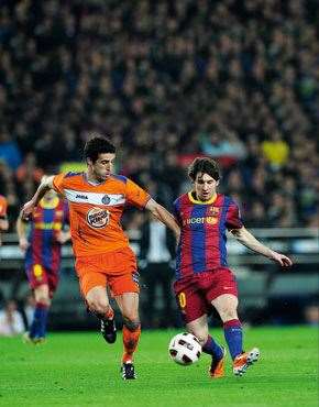 Sportsbiz Burger King’s – err Getafe’s – Ivan Marcano Sierra vies with Barcelona’s Lionel Messi.
