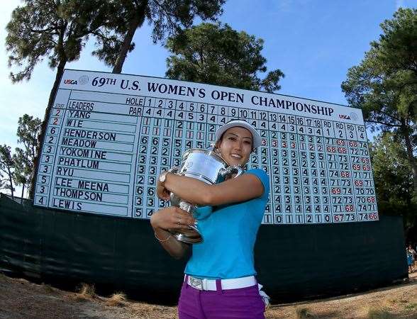 Michelle Wie proudly holds the trophy after her victory at the 69th U.S. Women's Open. PHOTO: Getty Images