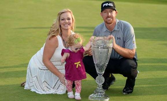 Hunter Mahan celebrates with his wife Kandi, daughter Zoe and the tournament trophy after winning The Barclays. PHOTO: Getty Images