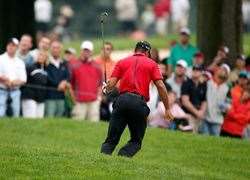 Tiger falls back into a bunker and the damage to his back is done. PHOTO: Getty Images