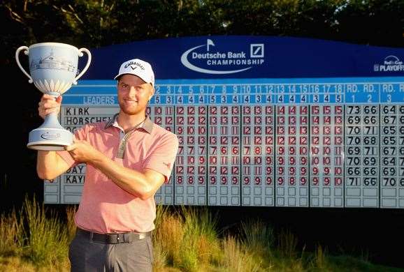 Chris Kirk is presented with the winner's trophy for the biggest win of his career. PHOTO: Getty Images.