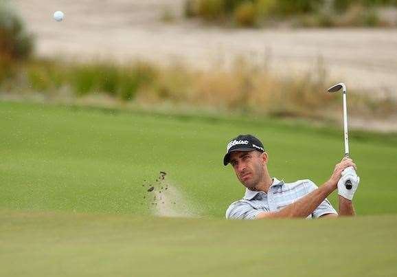 Geoff Ogilvy plays a bunker escape during his first round 69. The Sandbelt expert is well poised for a run at his first Gold Jacket. PHOTO: Getty Images.