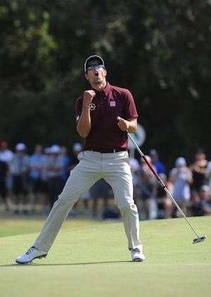 Adam Scott reacts after missing a putt on the final hole to grab a share of the lead. PHOTO: Getty Images