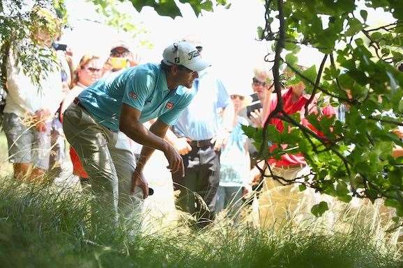 Adam Scott surveys the scene after missing the 5th fairway with his drive. He double bogied the hole and end his run at the title. PHOTO: Getty Images