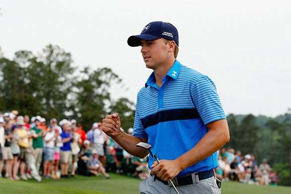 Jordan Spieth gives a little air punch after putting out on 18 to card an eight under 64 and lead the Masters by three shots. PHOTO: Getty Images.