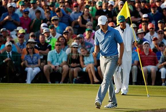 Spieth punches the air after saving his par at the last to maintain a for stroke lead heading into the final round. PHOTO: Getty Images.