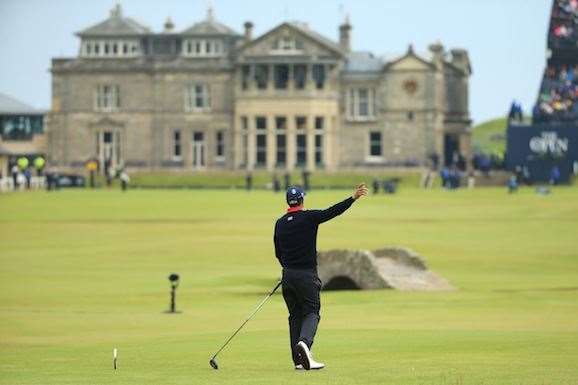 Adam Scott signals to the gallery as his drive on the 18th hole flies out of bounds. PHOTO: Andrew Redington/Getty Images.