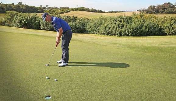 The ball on the left is on a firm-and-straight line; the right-hand ball is on a line for a softer putt with more break played.