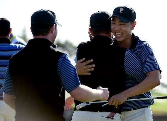 Sang-Moon Bae celebrates his putt to win his match with team mates Louis Oosthuizen and Branden Grace. PHOTO: Harry How/Getty Images