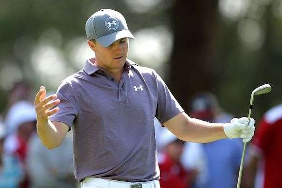 Jordan Spieth reacts after hitting his second shot on the 16th hole . PHOTO: Mark Metcalfe/Getty Images.