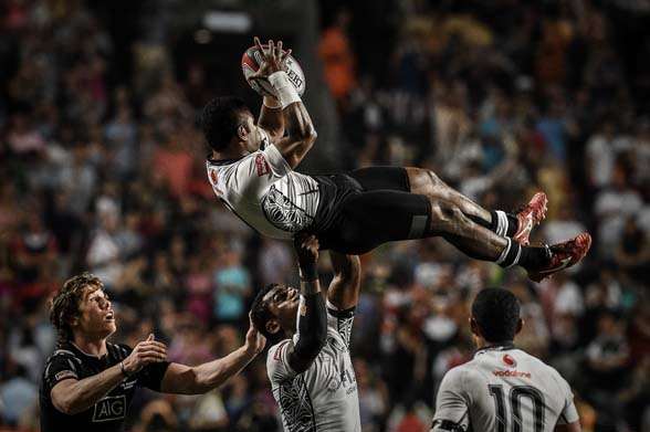 Fiji's Jerry Tuwai catches a ball against New Zealand during the final match on the third and final day of the rugby sevens tournament in Hong Kong on March 29, 2015. Fiji won 33-19. AFP PHOTO / Philippe Lopez (Photo credit should read PHILIPPE LOPEZ/AFP/Getty Images)
