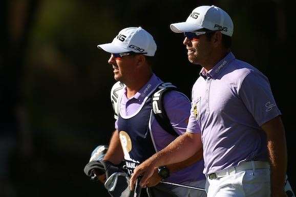 Oosthuizen and his caddie walk up the 18th fairway to generous applause. PHOTO: Paul Kane/Getty Images.