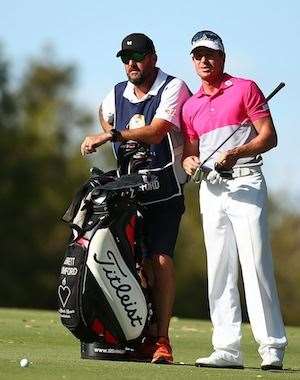 Brett Rumford talks with his caddie before playing his 2nd shot into the 18th hole. PHOTO: Paul Kane/Getty Images