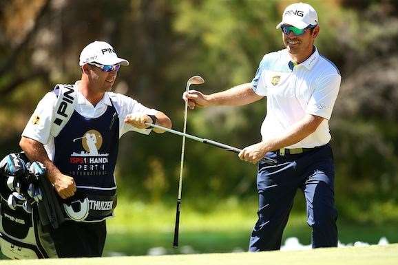 Oosthuizen smiles after chipping close to set up a birdie at the par-5 3rd hole. PHOTO: Paul Kane/Getty Images.