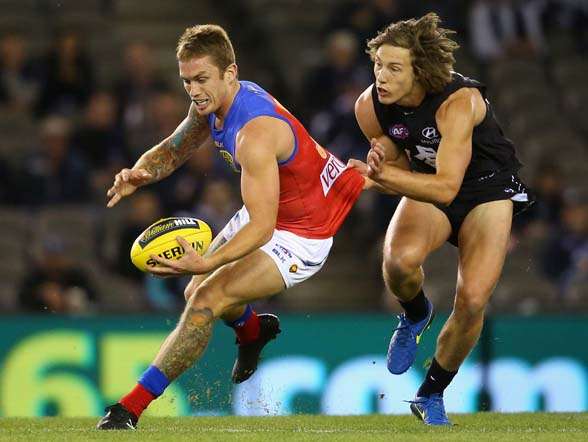 MELBOURNE, AUSTRALIA - MAY 10: Dayne Beams of the Lions is tackled by Mark Whiley of the Blues during the round six AFL match between the Carlton Blues and the Brisbane Lions at Etihad Stadium on May 10, 2015 in Melbourne, Australia. (Photo by Quinn Rooney/Getty Images)