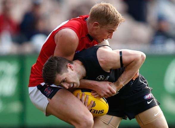MELBOURNE, AUSTRALIA - AUGUST 23: Marc Murphy of the Blues is tackled by Bernie Vince of the Demons during the 2015 AFL round 21 match between the Carlton Blues and the Melbourne Demons at the Melbourne Cricket Ground, Melbourne, Australia on August 23, 2015. (Photo by Michael Willson/AFL Media/Getty Images)