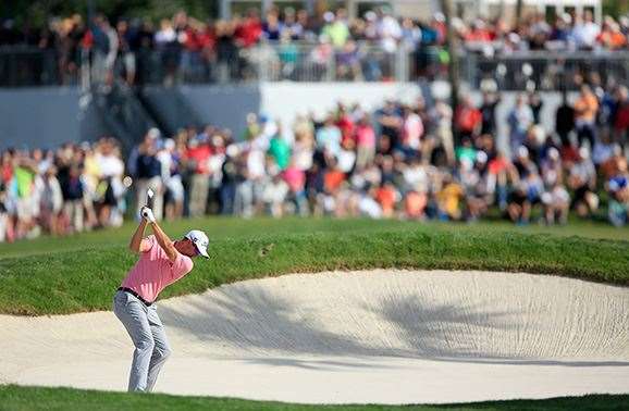 Scott fires his second shot into the par-4, 12th hole en route to victory. PHOTO: David Cannon/Getty Images.