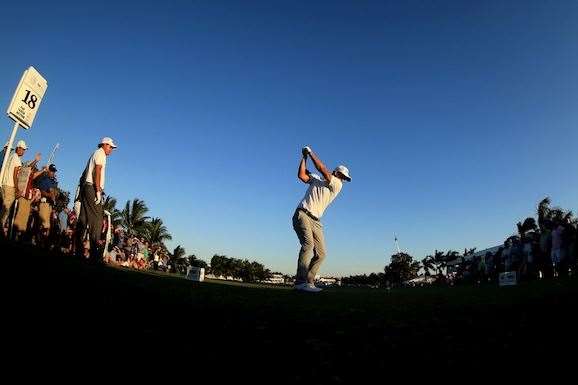 Adam Scott tees off on the 18th hole with victory in sight. PHOTO: Mike Ehrmann/Getty Images.