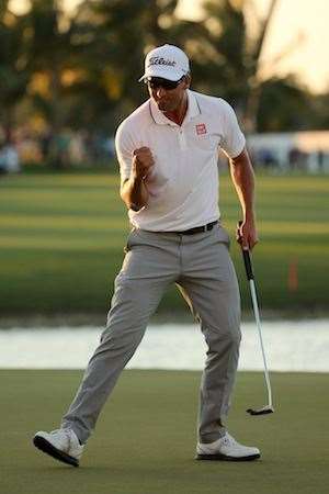 Scott celebrates after holing his six footer to save par and claim the win. PHOTO: Mike Ehrmann/Getty Images.