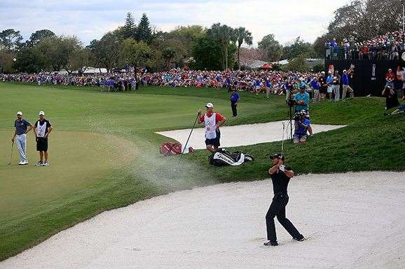 Jason Day hits a brilliant shot from a green side bunker on the 18th green to set up par and claim his win. PHOTO: Chris Trotman/Getty Images.