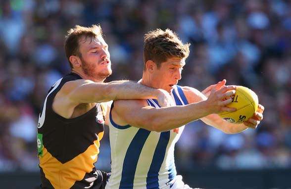 MELBOURNE, AUSTRALIA - SEPTEMBER 13: Nick Dal Santo of the Kangaroos marks infront of Kamdyn McIntosh of the Tigers during the First AFL Elimination Final match between the Richmond Tigers and the North Melbourne Kangaroos at Melbourne Cricket Ground on September 13, 2015 in Melbourne, Australia. (Photo by Quinn Rooney/Getty Images)