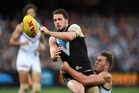 ADELAIDE, AUSTRALIA - SEPTEMBER 05: Travis Boak of the Power handballs during the round 23 AFL match between the Port Adelaide Power and the Fremantle Dockers at Adelaide Oval on September 5, 2015 in Adelaide, Australia. (Photo by Daniel Kalisz/Getty Images)