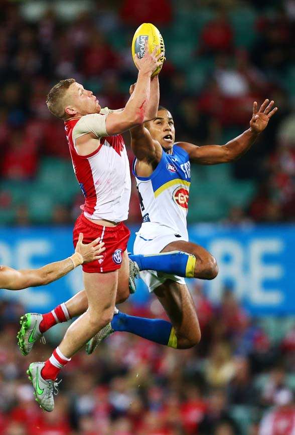 SYDNEY, AUSTRALIA - SEPTEMBER 05: Daniel Hannebery of the Swans is challenged by Touk Miller of the Suns during the round 23 AFL match between the Sydney Swans and the Gold Coast Suns at Sydney Cricket Ground on September 5, 2015 in Sydney, Australia. (Photo by Matt King/Getty Images)