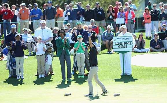 Mia Raines, aged 11, celebrates after holing a putt during the Drive, Chip and Putt Championship. PHOTO: Andrew Redington/Getty Images