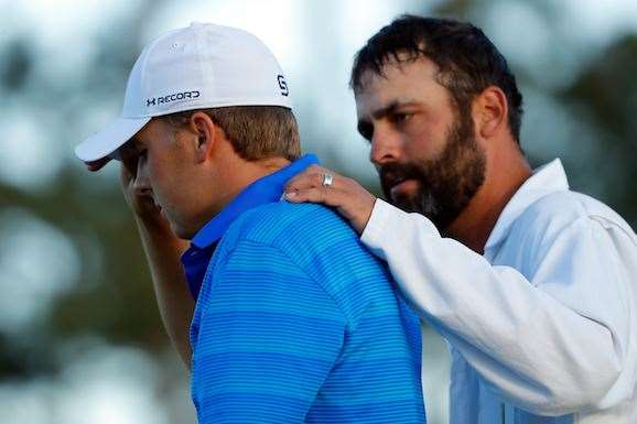 Caddie Michael Greller commiserates with Jordan Spieth, who uncharacteristically unravelled in a madcap half-hour from the 10th to 12th holes. PHOTO: Kevin C. Cox/Getty Images
