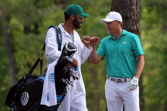 Jordan Spieth with caddie Michael Greller after another artistic escape. Spieth’s round ebbed and flowed but never saw a dropped shot on a windy Thursday at Augusta National. PHOTO: Andrew Redington/Getty Images