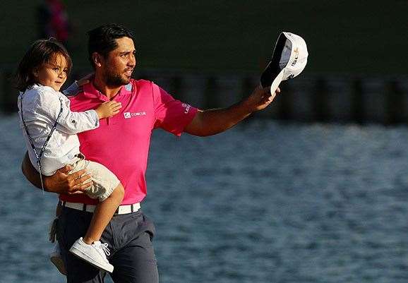 Day salutes the crowd with son, Dash, aftre his win. PHOTO: Mike Ehrmann/Getty Images.