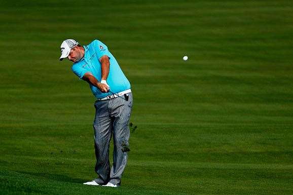Marc Leishman hits his approach into the 10th green during the first round. PHOTO: Christian Petersen/Getty Images.