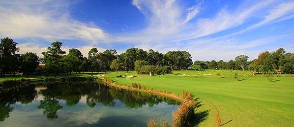 A pond and bunkers guard the approach to the green of the downhill par-4 4th hole.