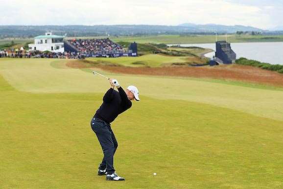 Noren fires his approach into the 18th hole en route to victory. PHOTO: Andrew Redington/Getty Images.