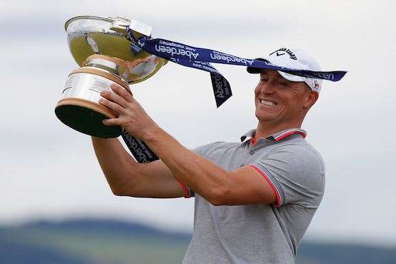 Alex Noren poses with the trophy in high winds at Castle Stuart. PHOTO: Kevin C. Cox/Getty Images.
