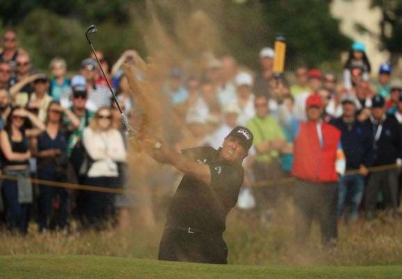 Mickelson blasts out of a bunker to set up another birdie at the par-5 16th. PHOTO: Mike Ehrmann/Getty Images.