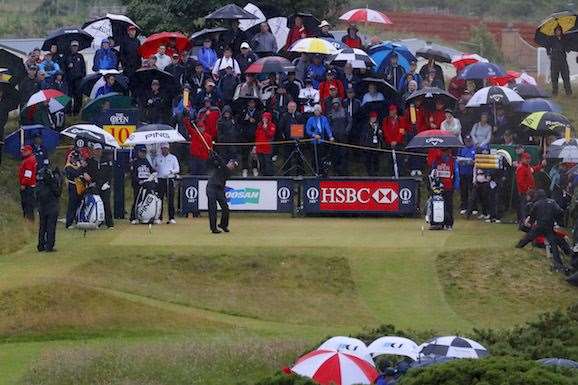 Phil Mickelson tees off on the 10th hole as rain starts to fall. PHOTO: Kevin C. Cox/Getty Images.