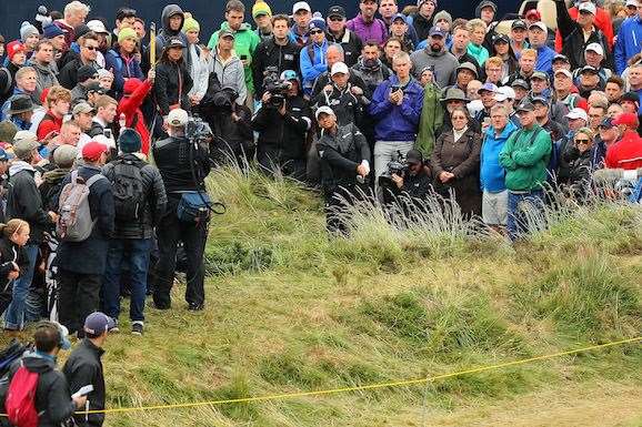 Jason Day plays a shot from the crowd on the 16th hole. He is T25 heading into the final round. PHOTO: Andrew Redington/Getty Images.