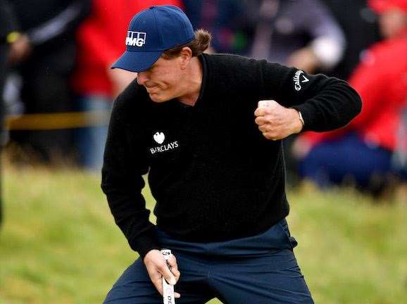Mickelson celebrates holing his long birdie putt on the 13th green. PHOTO: Stuart Franklin/Getty Images.
