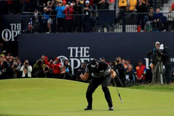 Henrik Stenson makes his putt for 63 and a place in Open and major championship history. PHOTO: Mike Ehrmann/Getty Images.