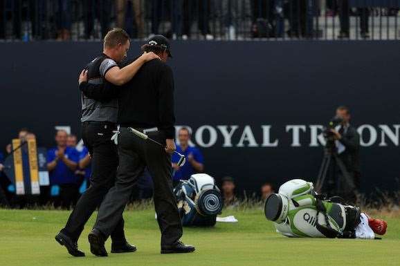 Stenson walks arm-in-arm off the 18th green with Phil Mickelson after their fantastic final round duel. PHOTO: Mike Ehrmann/Getty Images.