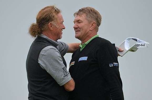 Broadhurst is embraced by playing partner Miguel Angel Jimenez, who let his chances of victory slip during the final round. PHOTO: Mark Runnacles/Getty Images.
