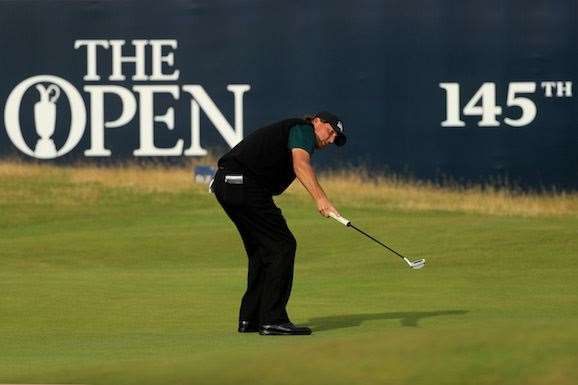 It's in ... Phil Mickelson watches his putt for 62 edge closer to the hole. PHOTO: Mike Ehrmann/Getty Images.