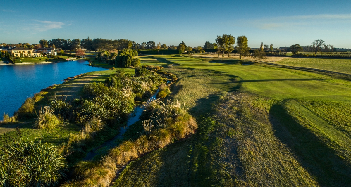The par-4 17th hole at Clearwater Golf Club showing the demanding approach to the tabletop style green with water hazards and the challenging greenside surrounds that have caught out players of all abilities