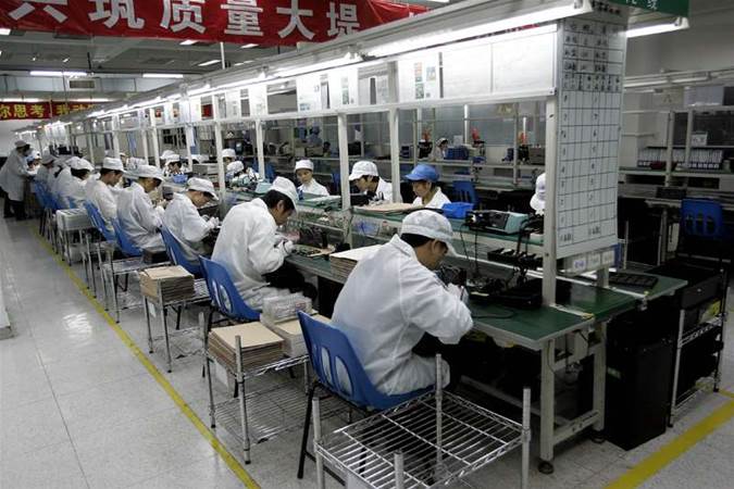 Image result for Workers on a tech production line in China. Pic: AFP