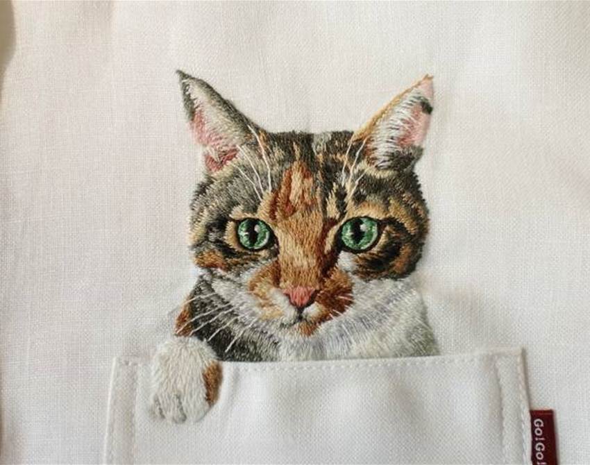 hiroko kubota embroiders cats onto shirt pockets