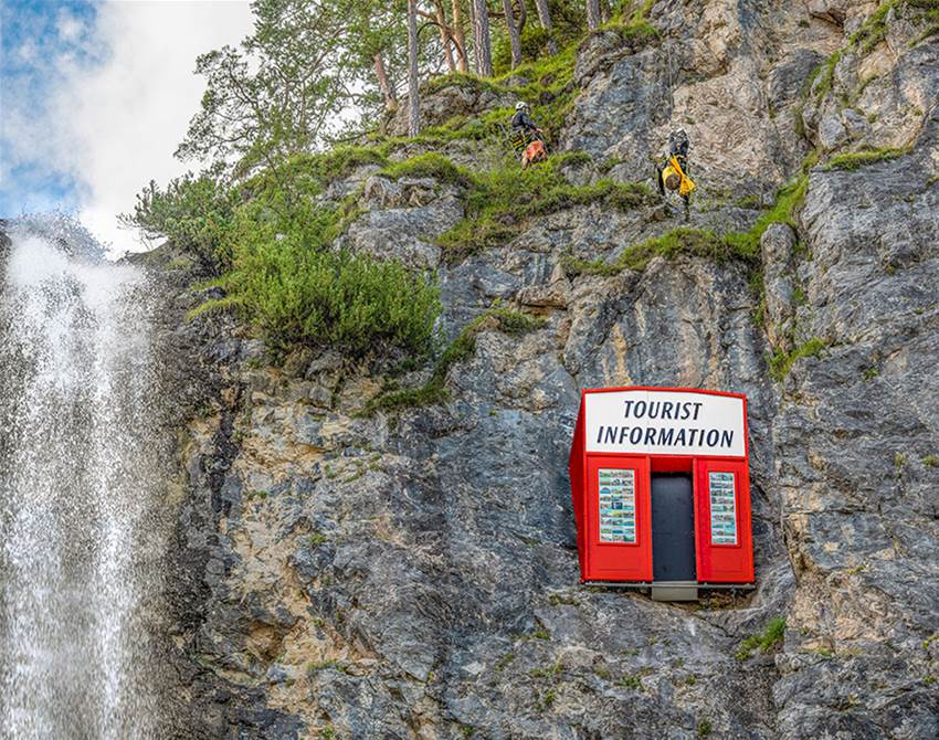 artists installed a tourist information booth on a cliff face