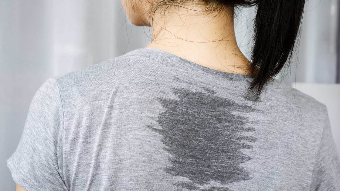Woman with a sweaty back from the gym. Sweating can lead to back acne. Woman with a sweaty back from the gym. Sweating can lead to back acne.
