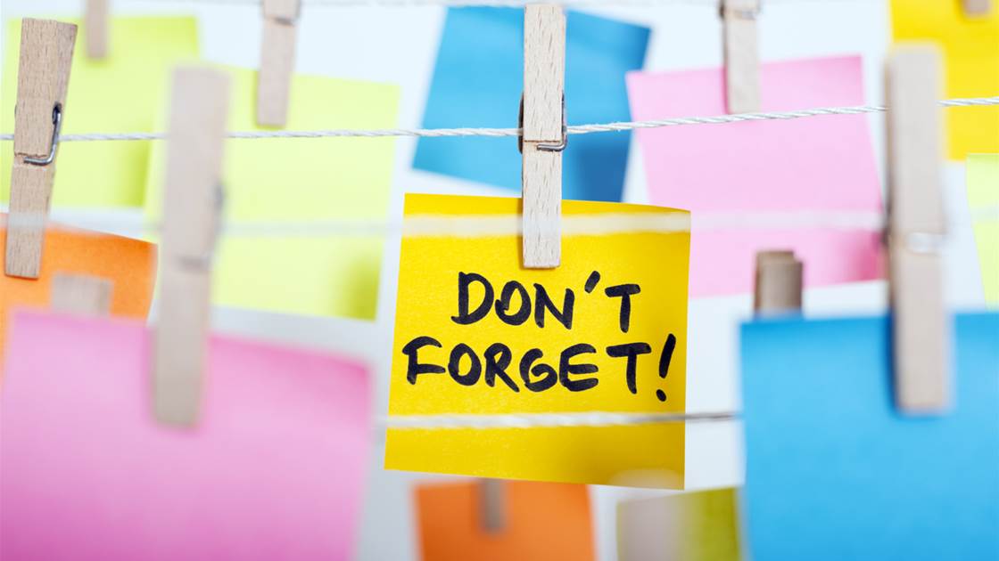 Post it notes hanging on the line with the words "don't forget" on one as a way to boost memory Post it notes hanging on the line with the words "don't forget" on one as a way to boost memory